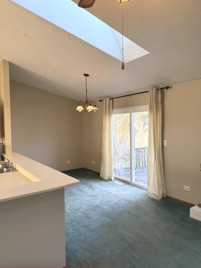 unfurnished dining area with carpet floors and a textured ceiling