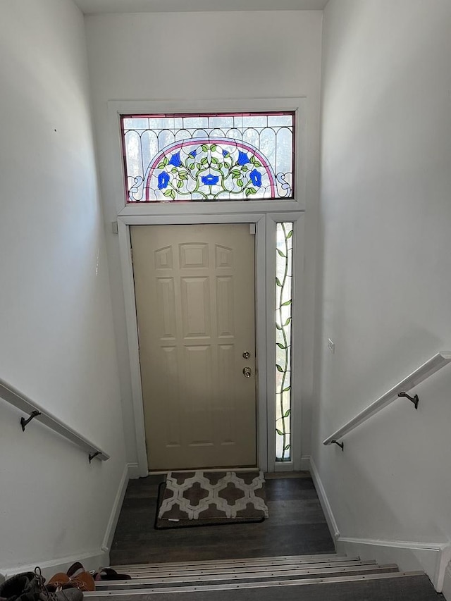 entrance foyer featuring a healthy amount of sunlight, baseboards, stairway, and wood finished floors