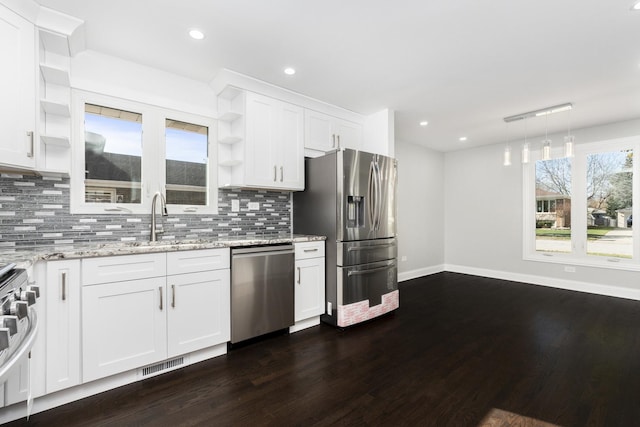 kitchen featuring open shelves, visible vents, backsplash, appliances with stainless steel finishes, and a sink