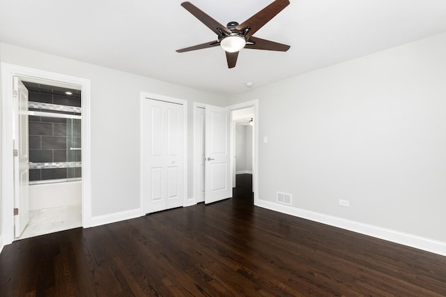 unfurnished bedroom featuring baseboards, visible vents, a ceiling fan, connected bathroom, and wood finished floors