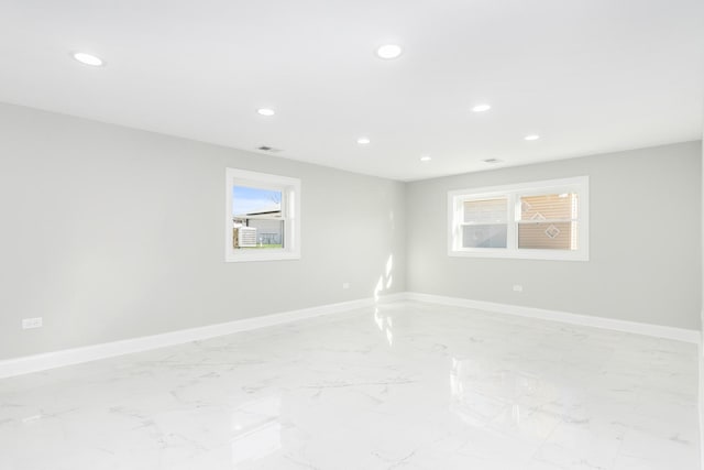 unfurnished room featuring recessed lighting, marble finish floor, and baseboards