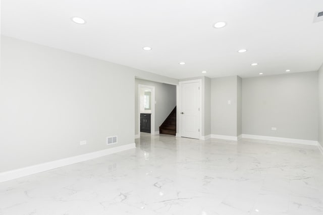 empty room featuring stairway, recessed lighting, visible vents, and baseboards