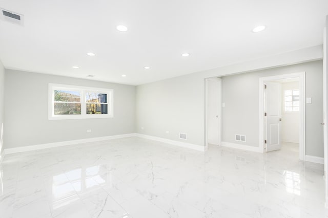 unfurnished room with baseboards, visible vents, a wealth of natural light, and recessed lighting