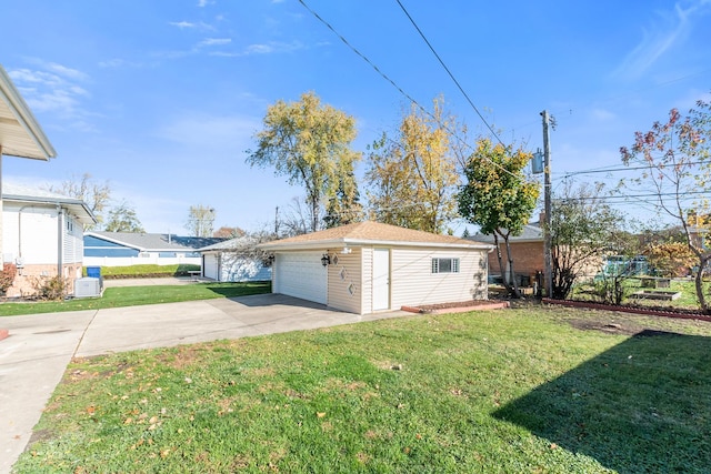 view of side of home with an outbuilding, a yard, and a garage