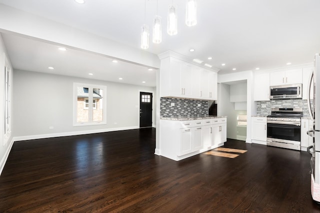 kitchen featuring white cabinetry, appliances with stainless steel finishes, open floor plan, and wood finished floors