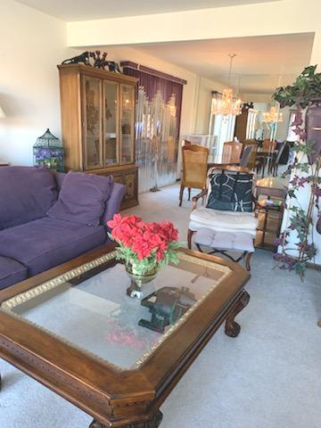 living room with a notable chandelier and carpet flooring