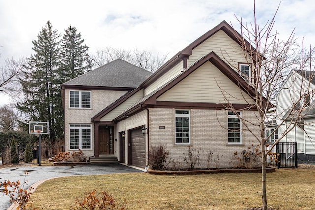 traditional-style house with aphalt driveway, brick siding, a garage, and a front lawn