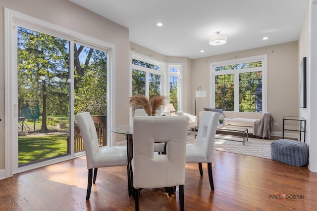 dining area with recessed lighting and wood finished floors