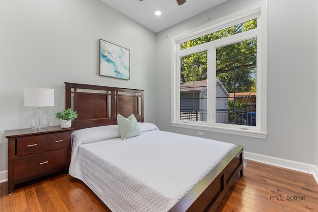 bedroom featuring wood-type flooring, baseboards, a ceiling fan, and recessed lighting