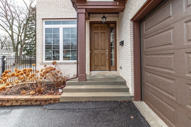 doorway to property with brick siding