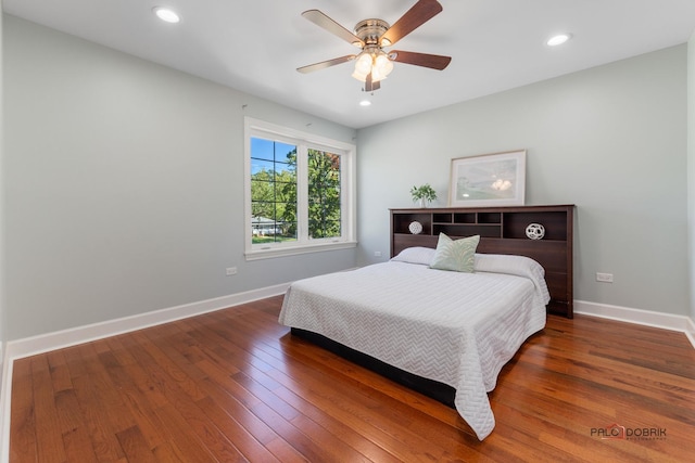 bedroom featuring a ceiling fan, recessed lighting, hardwood / wood-style flooring, and baseboards