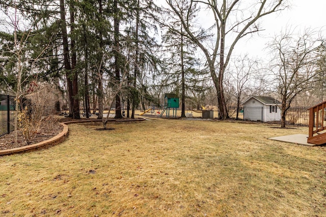 view of yard featuring a playground and fence