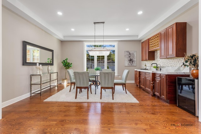 dining room with wine cooler, baseboards, dark wood finished floors, and recessed lighting