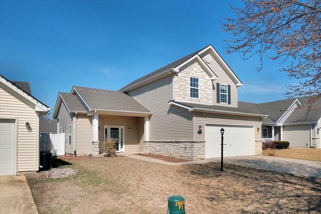 view of front of home featuring a garage, stone siding, driveway, and roof with shingles