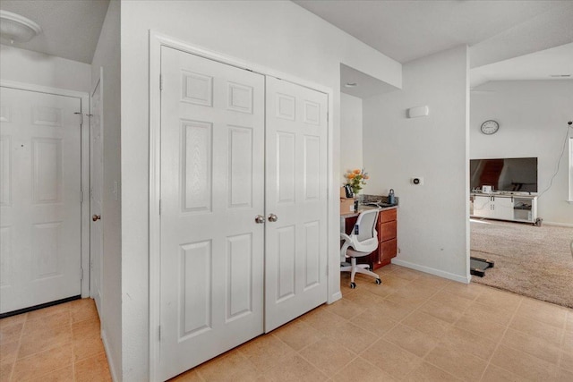 office with baseboards and light carpet