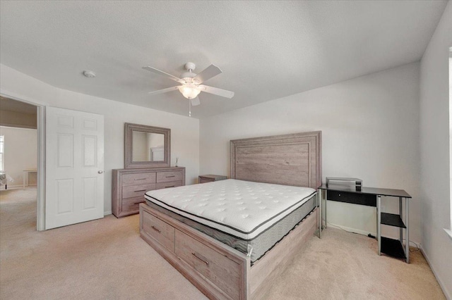 bedroom featuring light carpet, baseboards, and ceiling fan