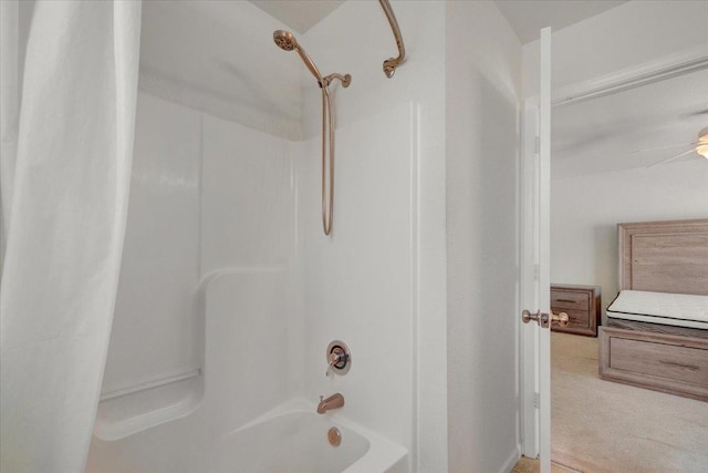 bathroom featuring a ceiling fan and shower / bath combo with shower curtain