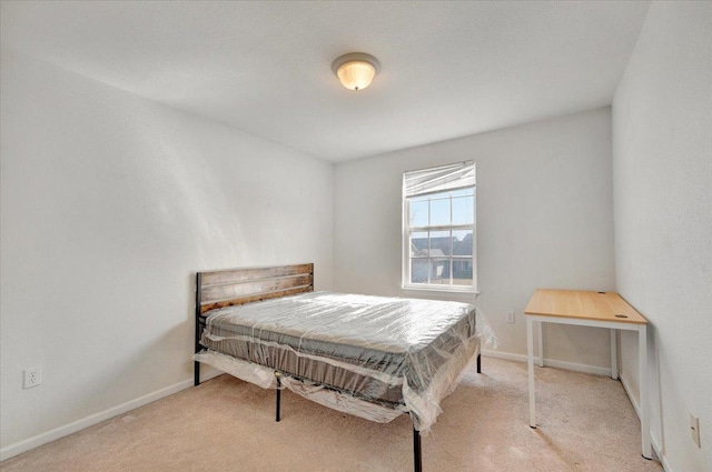 carpeted bedroom featuring baseboards