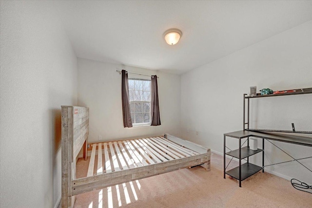 bedroom featuring baseboards and carpet