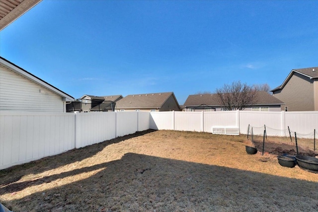 view of yard with a residential view and a fenced backyard