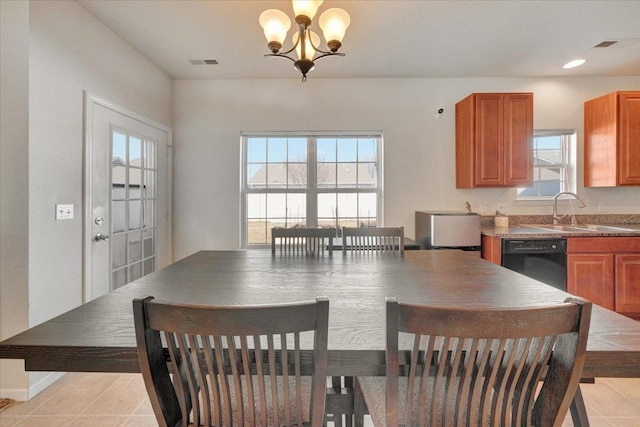 dining space with light tile patterned floors, visible vents, plenty of natural light, and a notable chandelier