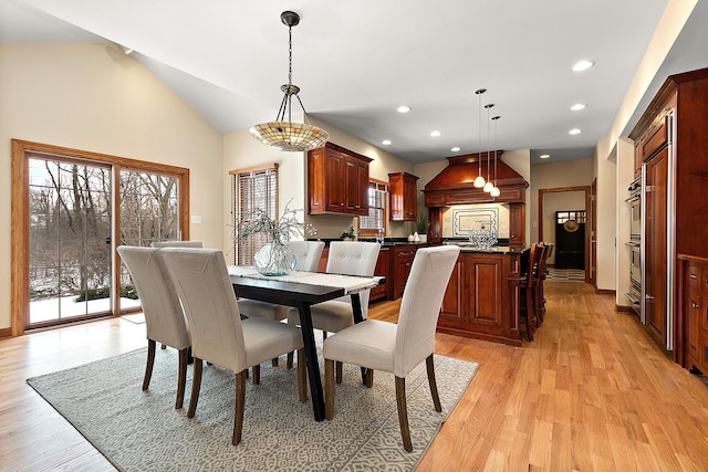 dining room with lofted ceiling, light wood finished floors, baseboards, and recessed lighting