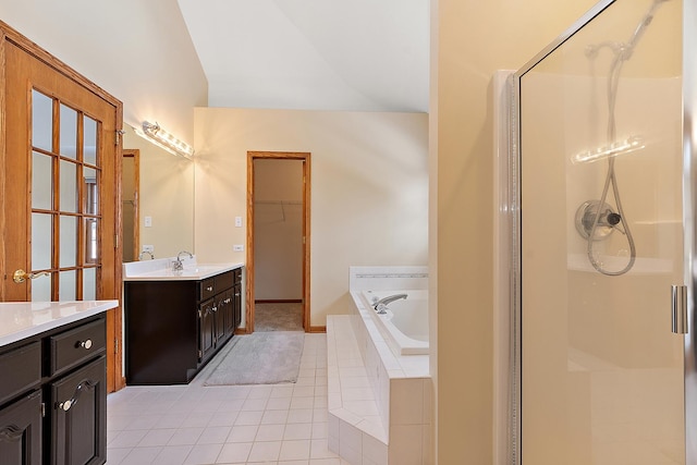 full bath with lofted ceiling, tile patterned flooring, vanity, a bath, and a stall shower