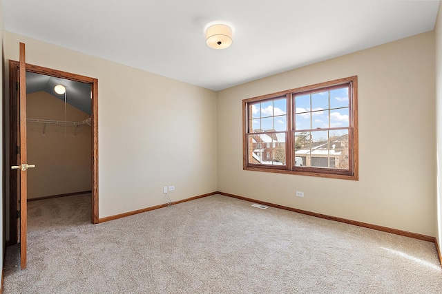 unfurnished bedroom with baseboards, visible vents, and light colored carpet