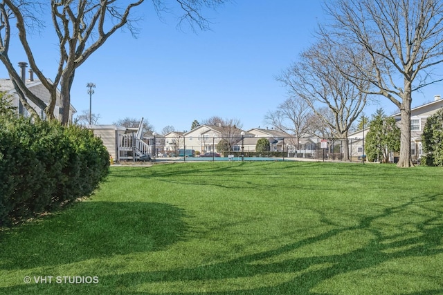 view of yard featuring a residential view and fence