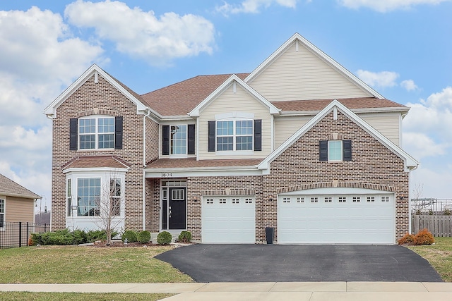 traditional-style house with brick siding, driveway, and fence