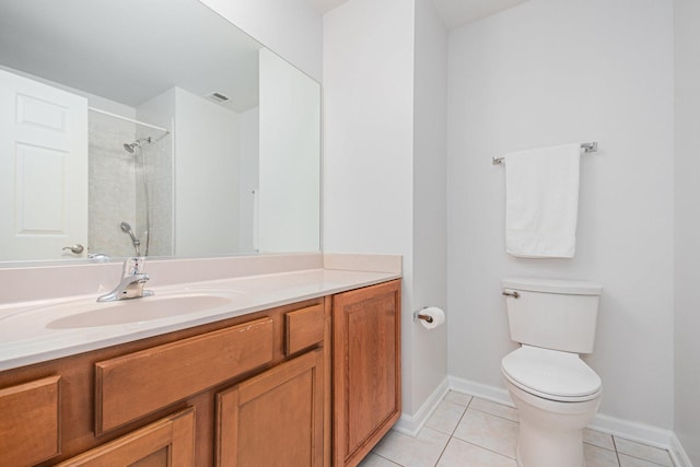 full bath featuring baseboards, toilet, tile patterned flooring, a tile shower, and vanity