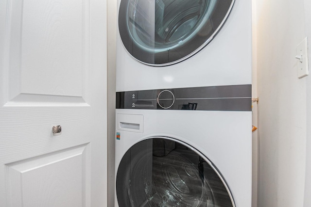 laundry room with stacked washer and dryer and laundry area