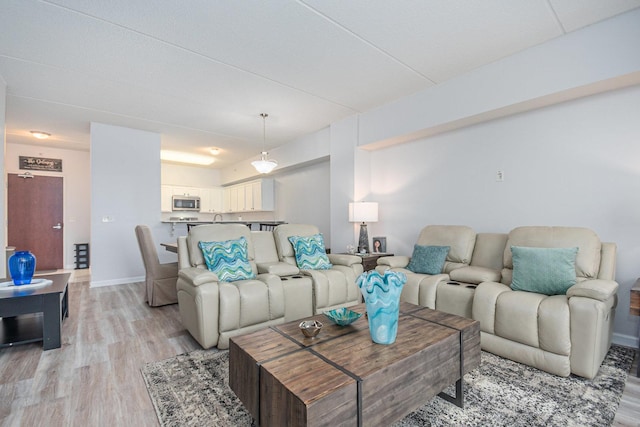 living room with light wood-style floors and baseboards