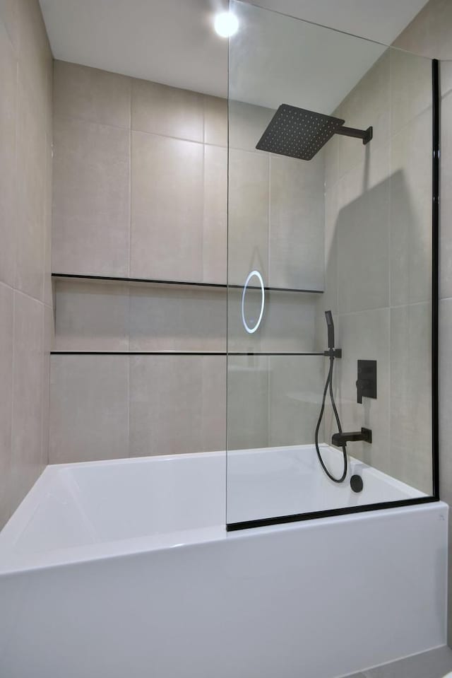 bathroom with a washtub, a tile shower, and tile walls