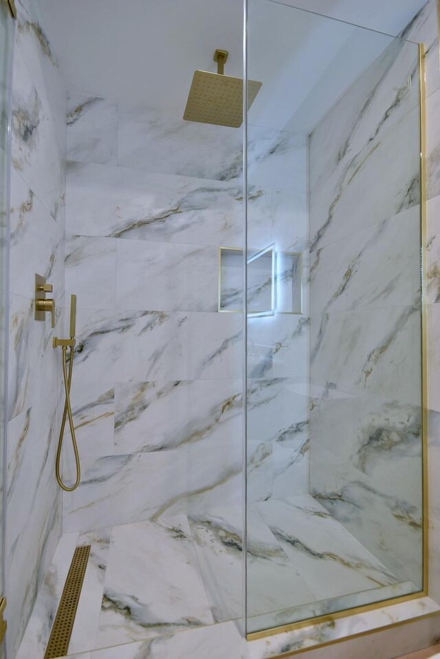 room details featuring a marble finish shower