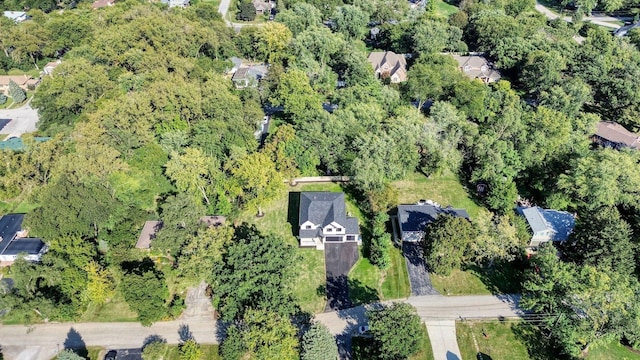 bird's eye view with a wooded view