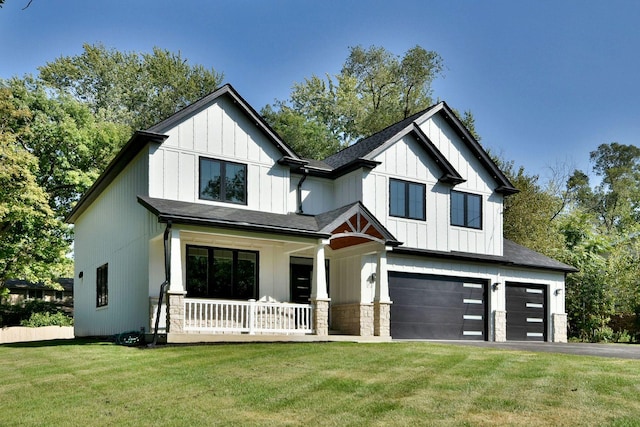 modern farmhouse style home featuring aphalt driveway, a porch, board and batten siding, a garage, and a front lawn