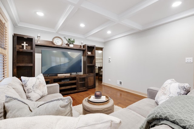 living area with beamed ceiling, coffered ceiling, wood finished floors, and visible vents