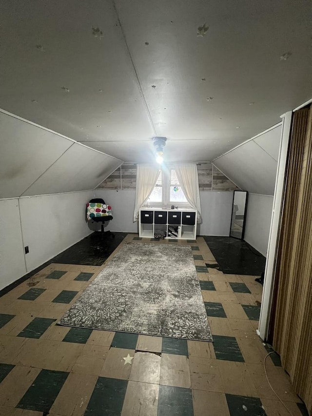 bonus room featuring vaulted ceiling and tile patterned floors