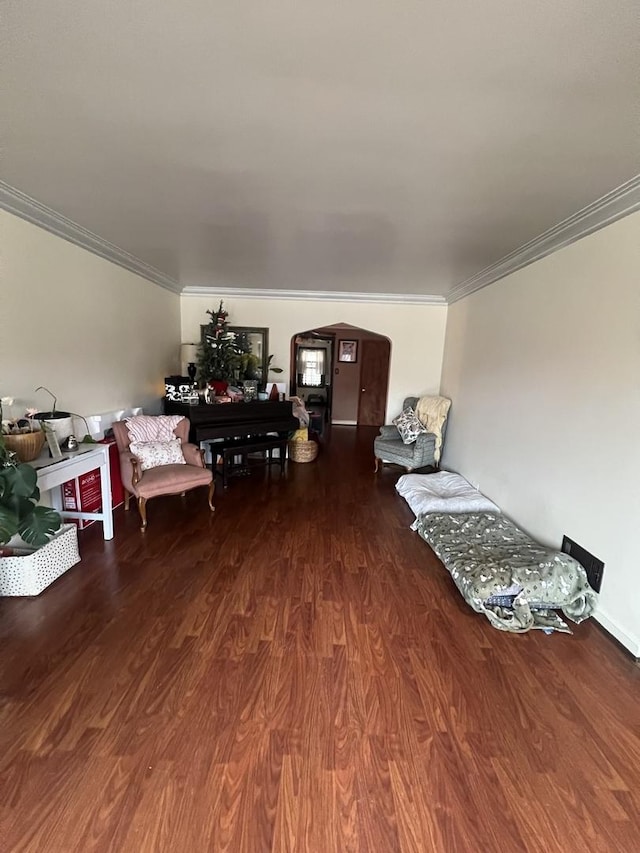 living area featuring ornamental molding and wood finished floors