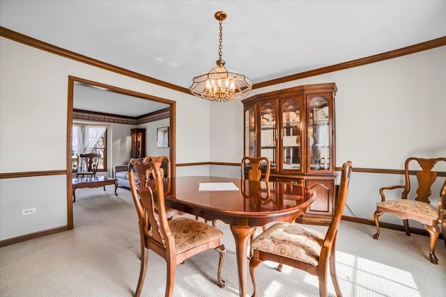 dining space featuring baseboards, a chandelier, and light carpet