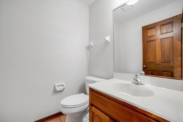 half bathroom featuring toilet, vanity, and tile patterned flooring