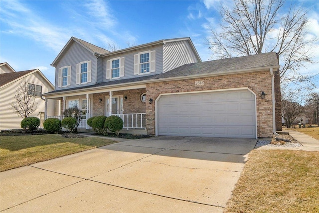 traditional-style house with driveway, a porch, a front lawn, a garage, and brick siding