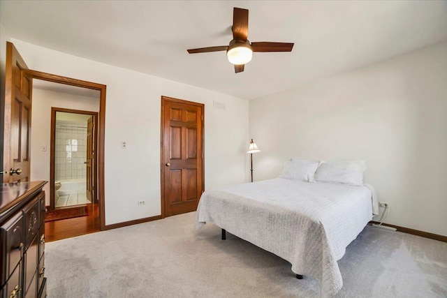 bedroom featuring light carpet, visible vents, and baseboards