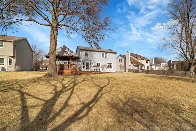 back of house with a gazebo, fence, a lawn, and a wooden deck