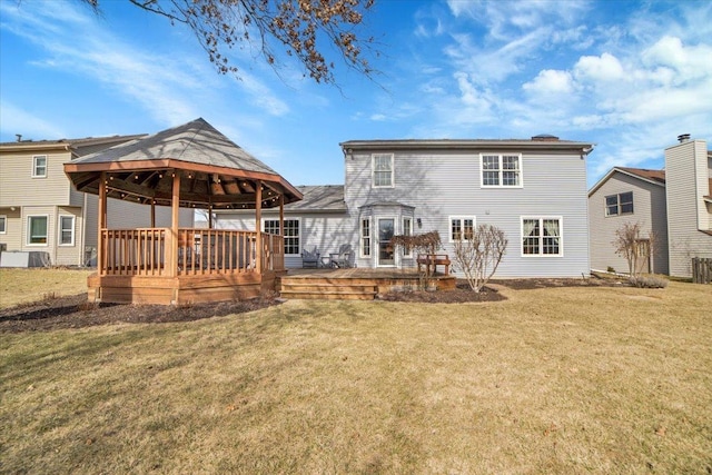 back of house with a deck, a gazebo, and a yard