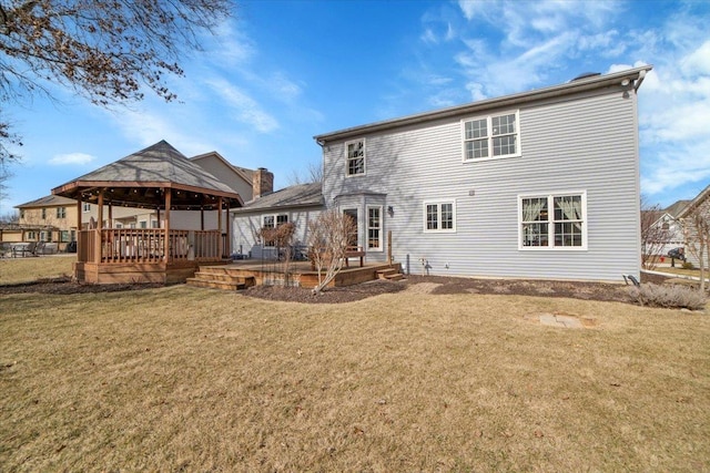 rear view of house with a gazebo, a yard, and a wooden deck