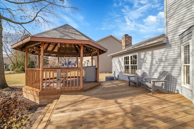 wooden terrace featuring a gazebo