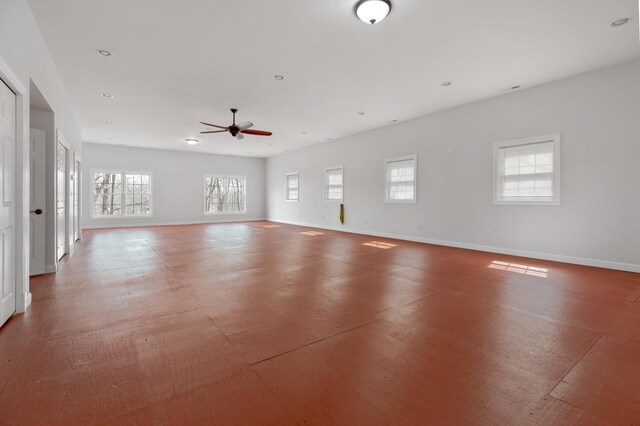 spare room featuring a healthy amount of sunlight, baseboards, and recessed lighting