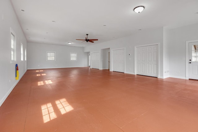 garage with ceiling fan and baseboards